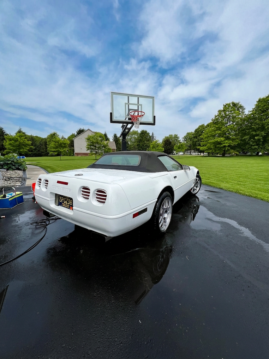 White Corvette convertible rear three-quarter, freshly washed