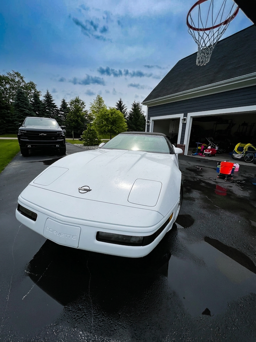 White Corvette convertible front end after wash